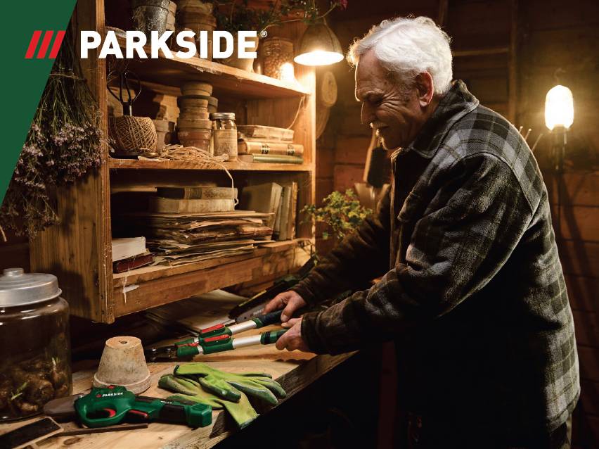 Възрастен мъж използва градински ножици Parkside в работилница.