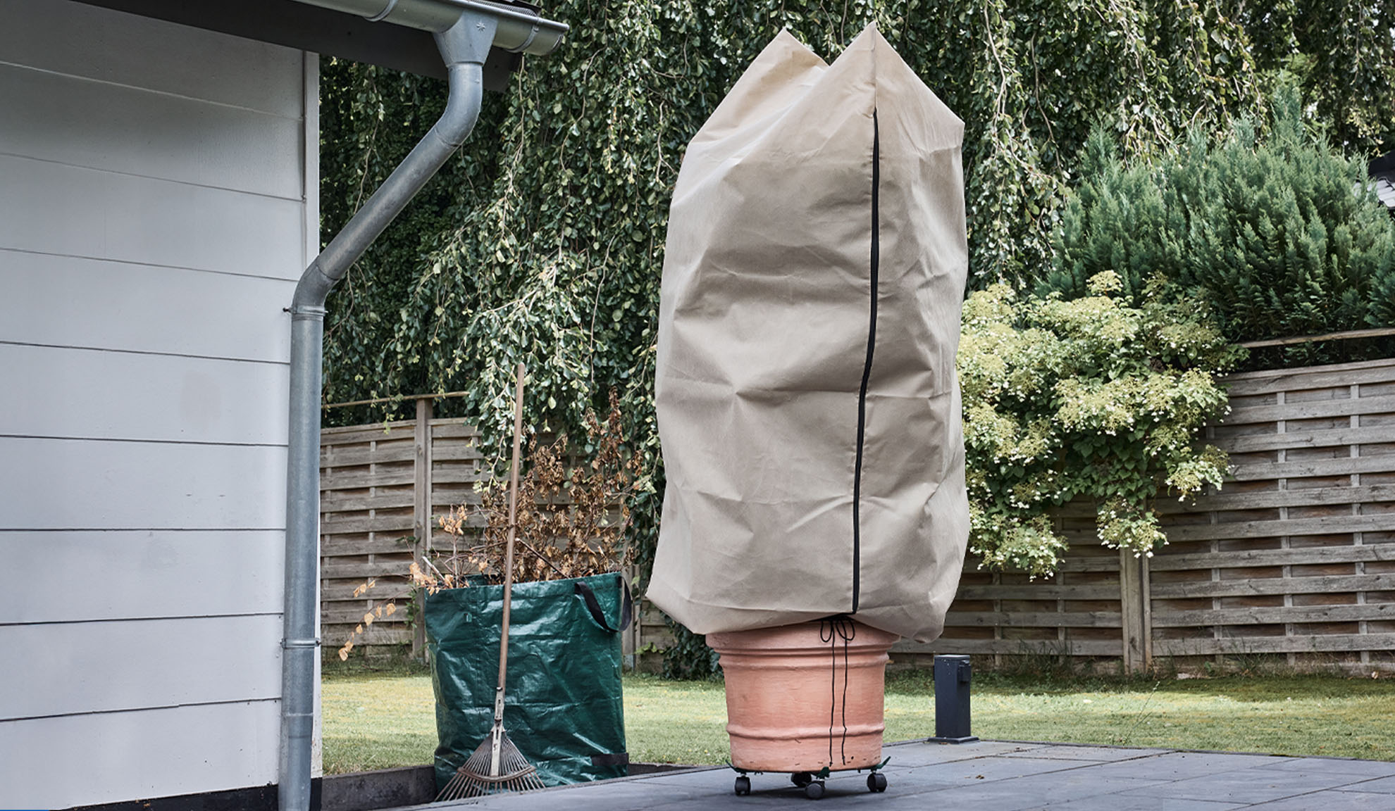 Покривало за растение в саксия на тераса с улук и гребло.